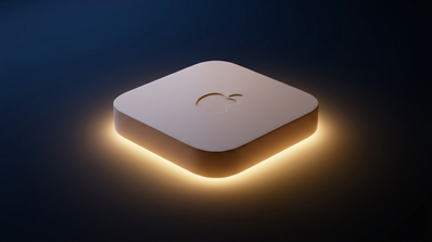 Mac mini de Apple iluminado desde la base sobre un fondo oscuro.