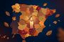 Ilustración del mapa de España con motivos otoñales y una vela encendida en el centro sobre un fondo oscuro.