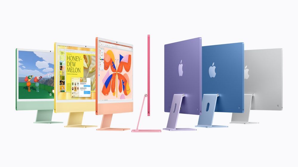 Siete ordenadores Apple iMac de diferentes colores dispuestos en abanico sobre fondo blanco, mostrando sus perfiles finos y la parte trasera.